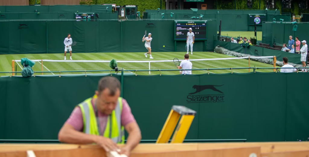 Ongoing Maintenance Work at The All England Club In Preparation For Wimbledon 2023 as Jannik Sinner Hits in the Background
